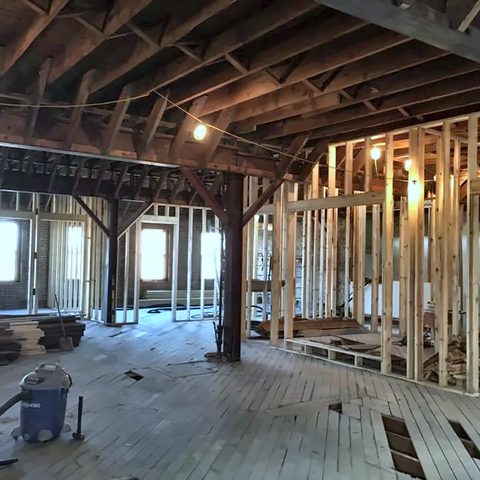 A large commercial interior stripped back to timber framing and posts during a fit-out