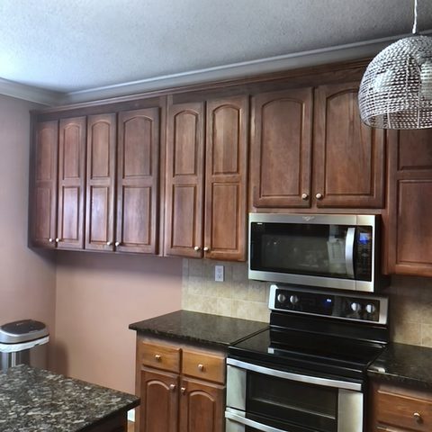 Another kitchen before work, with dark cherry cabinets and a tiled backsplash